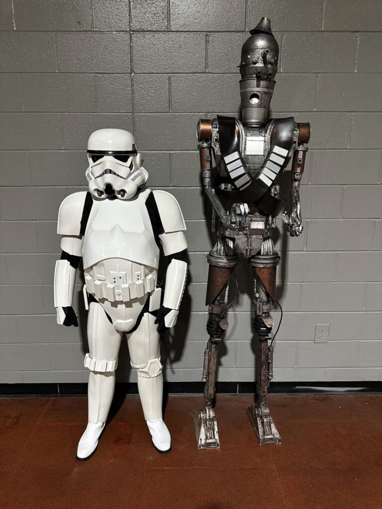 A Stormtrooper standing next to a droid, IG-88